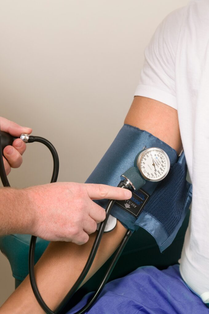 Healthcare worker checking a patient's blood pressure