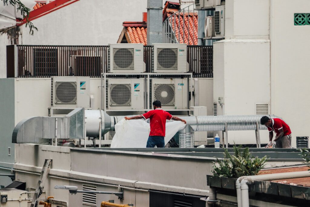 HVAC technicians working on rooftop air conditioning units