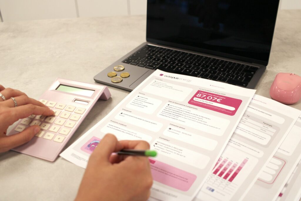 Person calculating training costs with documents and a calculator