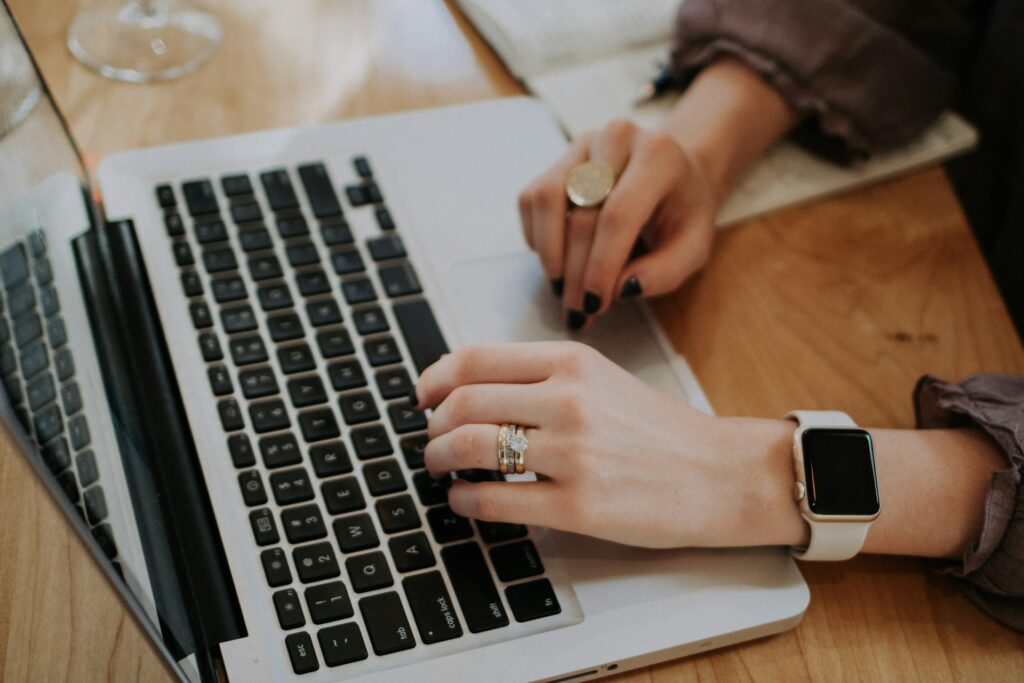 Person researching an online trade school on a laptop