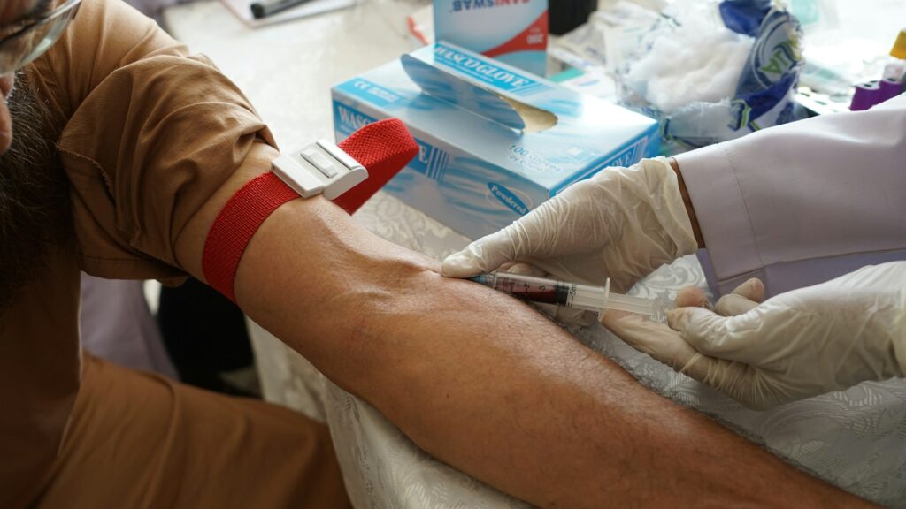 Phlebotomist drawing blood from a patient's arm